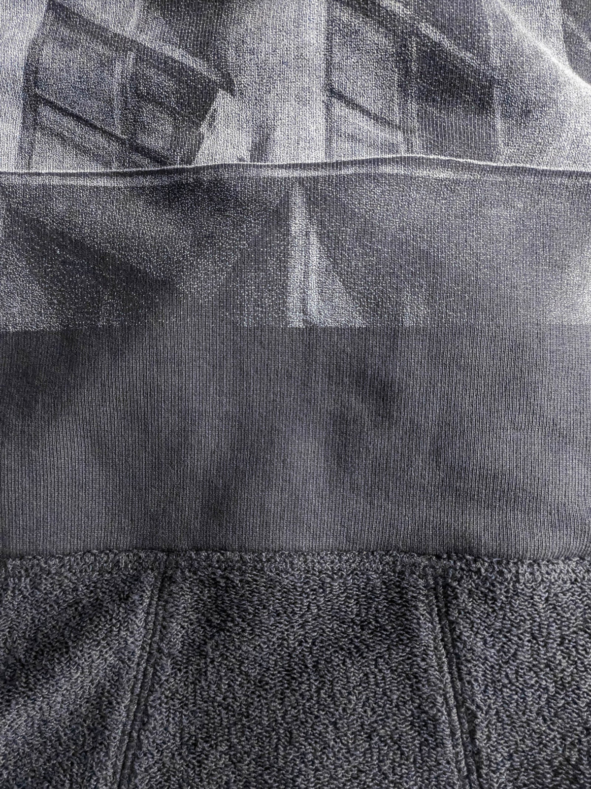 Close-up of a textured gray fabric with a high-quality screen print for long-lasting wear.